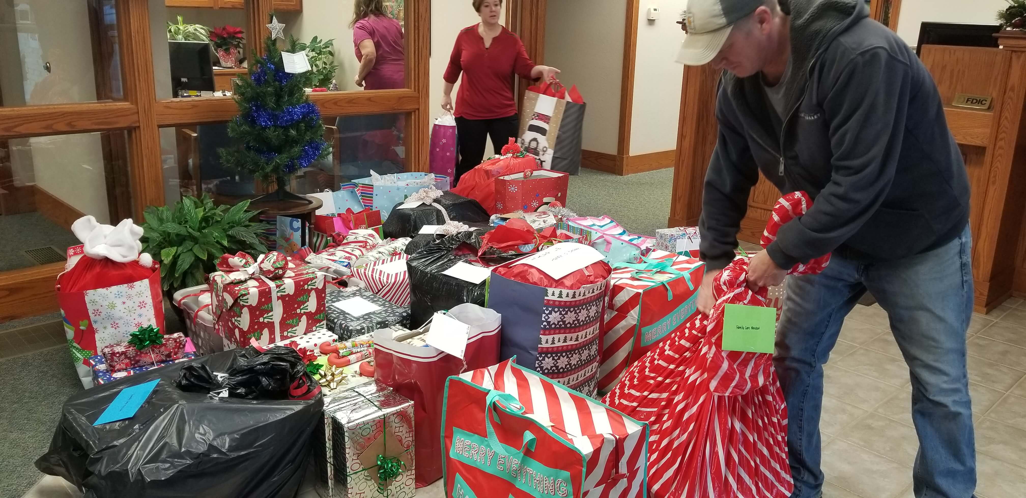 Blue Valley Telecommunications employee carries away the gifts for distribution.