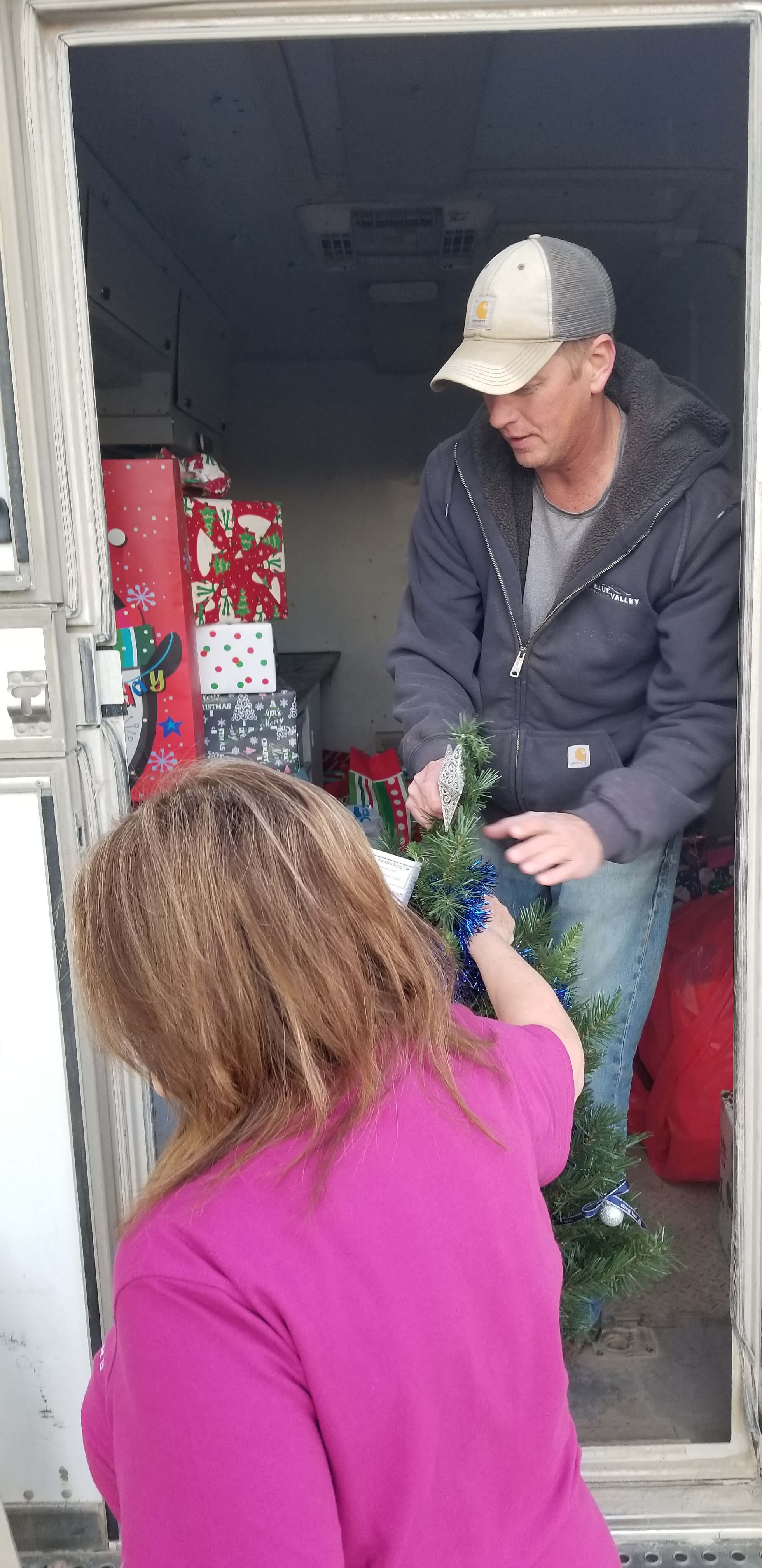 Employees help load gifts for the Giving Tree.